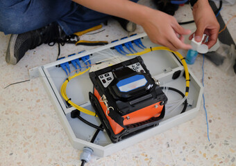 Technicians are cutting and fusion fiber optic cables.