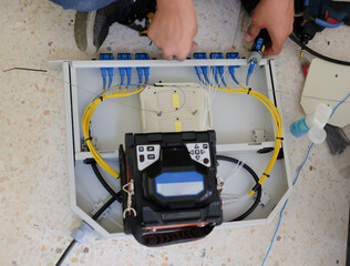Technicians are cutting and fusion fiber optic cables.