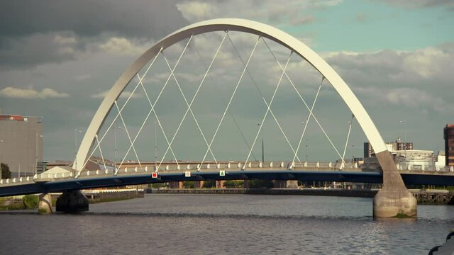 Lockdown shot of cars on famous The Clyde Arc over River Clyde in city - Glasglow, Scotland