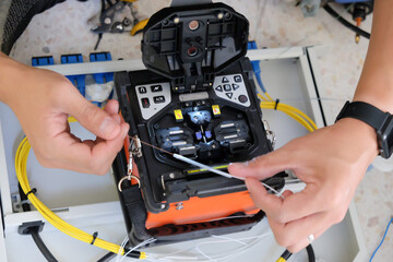 Technicians are cutting and fusion fiber optic cables.