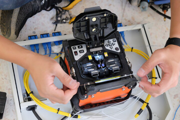 Technicians are cutting and fusion fiber optic cables.