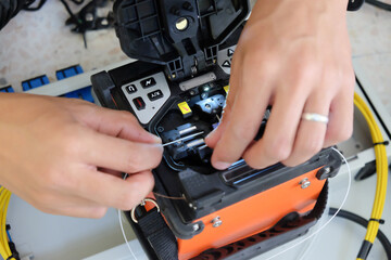 Technicians are cutting and fusion fiber optic cables.