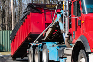 truck loading a full skip recycling garbage waste management container © Victor