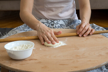 Homemade lahmacun preparation from start to finish. Dough rolls on the floor table