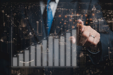 businessman pointing to financial growth chart with city picture background
