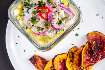 Peruvian seafood: fish cebiche with onion, chili, sweet corn and sweet potato