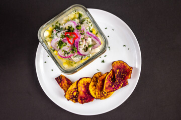 Peruvian seafood: fish cebiche with onion, chili, sweet corn and sweet potato