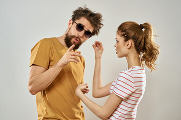 man in sunglasses next to woman in striped t-shirt emotions communication fashion studio fun