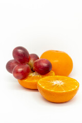 Citrus fruits and grapes on white background
