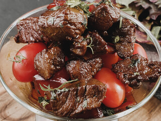 Sliced grilled beef barbecue steak and salad with tomatoes and arugula