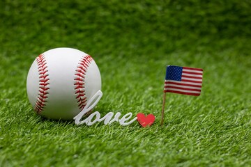 Baseball is on green grass with love word 