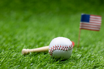 Baseball with flag of America on green grass