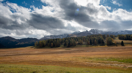 Fototapeta na wymiar Landscape with beautiful autumn meadow field and the amazing Dolomite rocky peaks. Valley of Alpe di siusi Seiser Alm South Tyrol Italy.