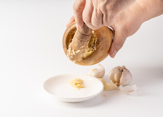 Wood-mashed garlic on a pure white background