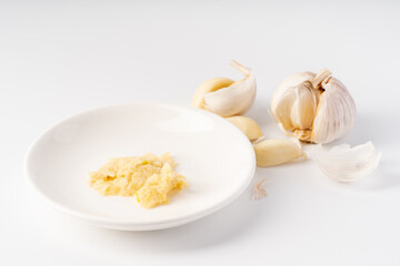 Wood-mashed garlic on a pure white background