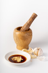 Wood-mashed garlic on a pure white background