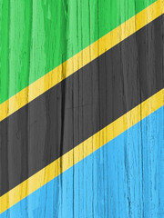 The flag of Tanzania on dry wooden surface, cracked with age. Vertical background, wallpaper or backdrop with Tanzanian national symbol