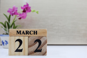Day 22 of March month, Wooden calendar with date on the desk.