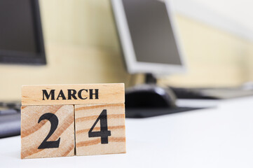 Day 24 of March month, Wooden calendar with date on the desk.