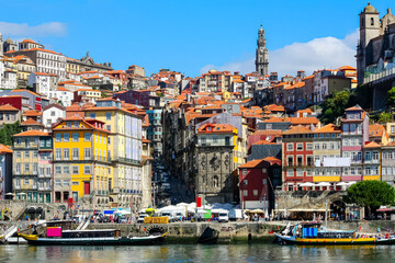 Fototapeta na wymiar Cityscape of the city of Porto, Douro river with its old boat and its typical colored houses on the water's edge. Portugal.