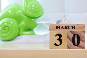 Day 30 of March month, Wooden calendar with date on the desk.