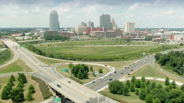 Aerial: Freeway traffic interchange and the Winston-Salem city skyline, North Carolina, USA
