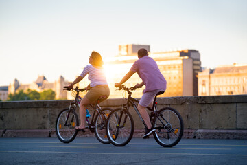 Mature couple riding bikes in the city