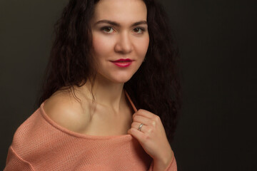 Studio portrait of a brunette in peach dress