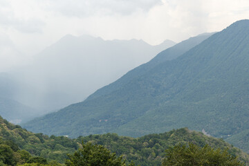 Misty mountain landscape with fir forest. Beautiful landscape with mountain view, cable car. Postcard view. Travel concept