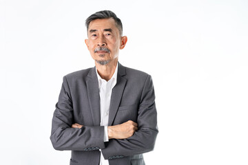 A senior Asian businessman in a classic gray suit shirt is happy, smiles, and proud. He has Crossed his arms with two hands. Studio shot over white background. Elderly, Positive and vision Concept