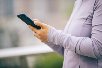 Asian woman skateboarder skateboarding in modern city