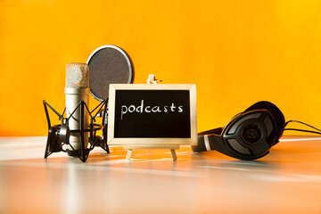 Professional microphone with waveform and headphones on yellow background banner. Podcast or...
