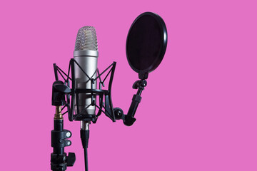 Professional microphone with waveform and headphones on a pink background banner. Podcast or...