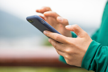 people hands using smartphone outdoors