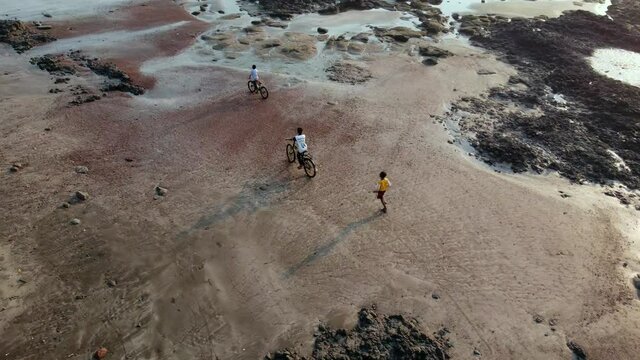 Aerial view of kids playing at Ladghar beach Dapoli, located 200 kms from Pune on the West Coast of Maharashtra India.