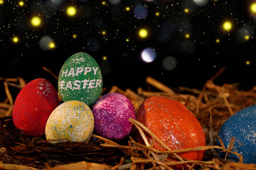 beautiful colorful Easter eggs lie on the straw with a shiny background