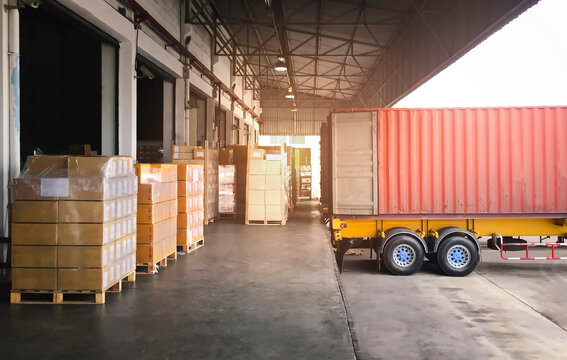 Cargo Container Truck Parked Loading at Dock Warehouse. Cargo Shipment. Industry Freight Truck Transportation. Shipping Warehousing Logistics.