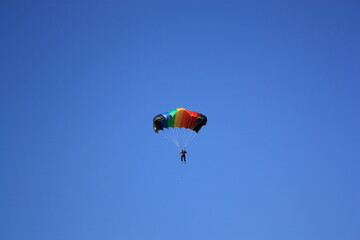 Parasailing, parachutist against the blue sky. High quality photo