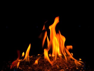 Big orange flame of outdoor fire pit close up and isolated  