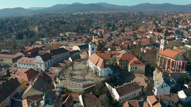 Szentendre, Hungary - 4K flying around the Saint John the Baptist's Parish Church and the Belgrade Serbian Orthodox Cathedral on a sunny winter day