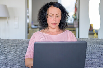 Obraz na płótnie Canvas Woman working on her computer