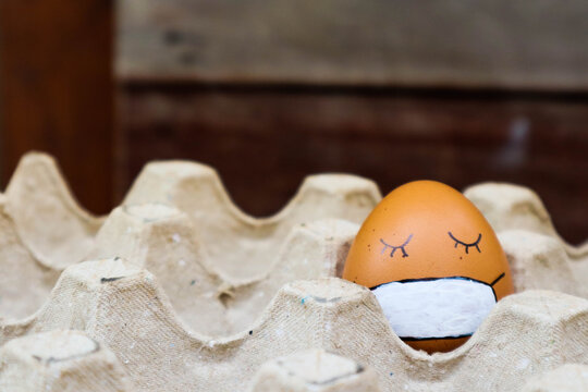 Easter eggs with sleeping face in medical masks.