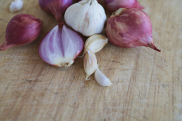 Onion and garlic for cooking on old wooden background