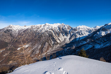 Fototapeta na wymiar Mountain range of the Monte Carega in winter with snow, also called the Small Dolomites (Piccole Dolomiti) from the Altopiano della Lessinia (Lessinia Plateau). Veneto and Trentino Alto Adige, Italy.