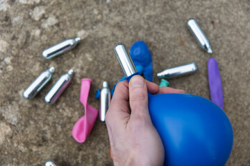 Nitrous oxide metal bulbs or laughing gas recreational drug use - obrazy, fototapety, plakaty
