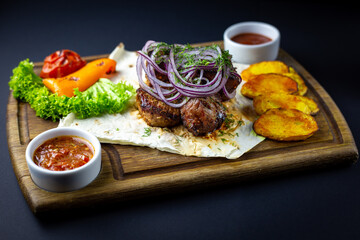 Pork skewers BBQ with onion, grilled veggies and tomato sauce.