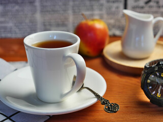 cup of tea and cookies on wooden table