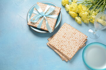 Fototapeta na wymiar Table served for Passover (Pesach) indoors, with matzah bread as symbolic Pesach (Passover Seder) item.