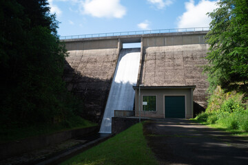 Fototapeta na wymiar water flows powerfully from a dam in Thuringia