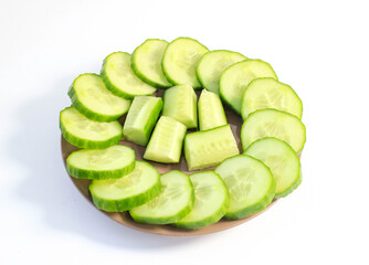 Fresh sliced cucumbers are laid out on a plate.